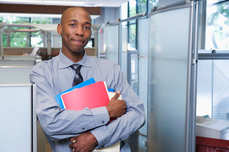 Young, male paralegal with files